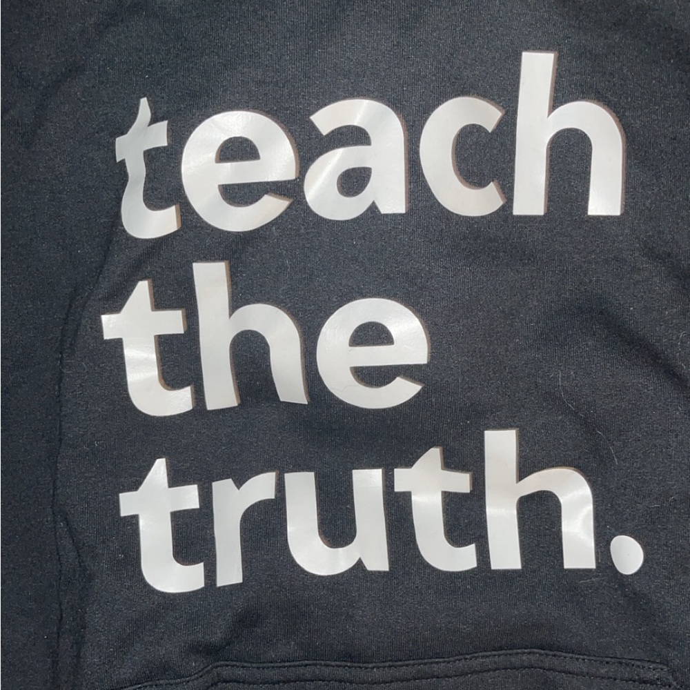Teach the truth  hoodie. Normal wear and tear in high traffic areas